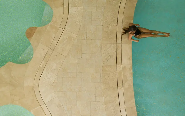 a girl is sitting on a thalassotherapy pool at Anazoe Spa